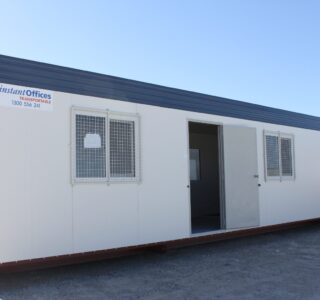 Portable modular office building by Instant Offices featuring white walls, security windows, and a blue roof.