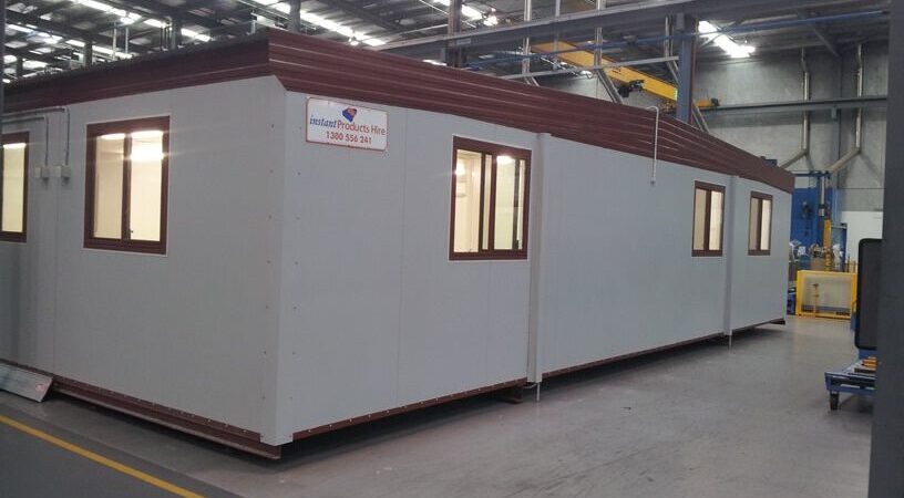 Modular office building inside a warehouse, ready for deployment
