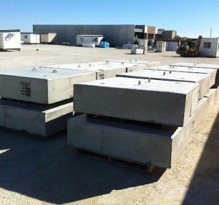 Instant Products pre-cast concrete blocks stacked in storage area at a construction site