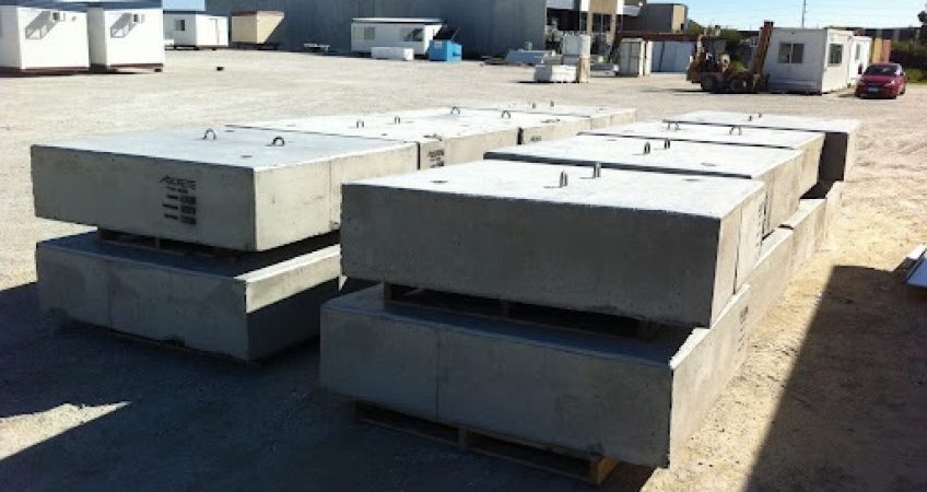 Instant Products pre-cast concrete blocks stacked in storage area at a construction site