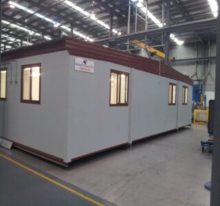 Modular office building inside a warehouse, ready for deployment